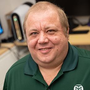 headshot of Francisco, smiling, wearing green collared shirt