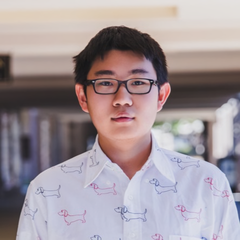 headshot of Fuheng wearing a white collared shirt with dogs and black rimmed glasses