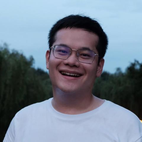 headshot of Jiaheng Zhang from the shoulders up, wearing a white t-shirt and black rimmed glasses, smiling