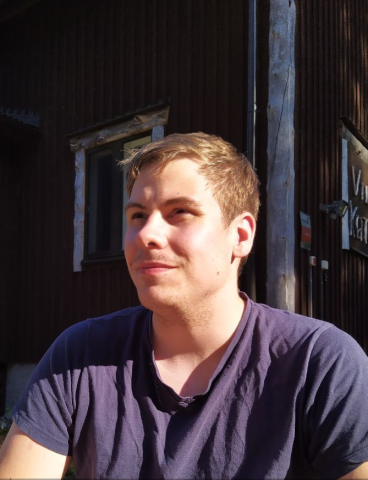 headshot of Tuukka, wearing a black t-shirt, smiling