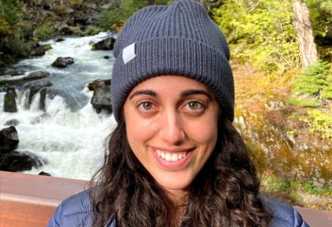 headshot of Sharon, smiling with blue beanie 