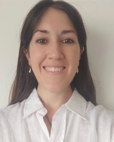 headshot of Melani Sánchez García from the shoulders up, wearing a white collared shirt and smiling with teeth