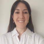 headshot of Melani Sánchez García from the shoulders up, wearing a white collared shirt and smiling with teeth